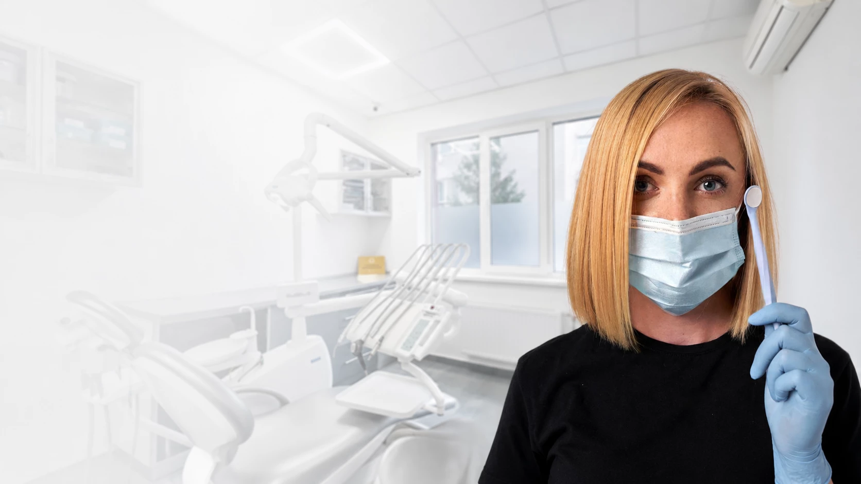 Лікарка DRT Clinic зі стоматологічним дзеркалом у сучасному кабінеті